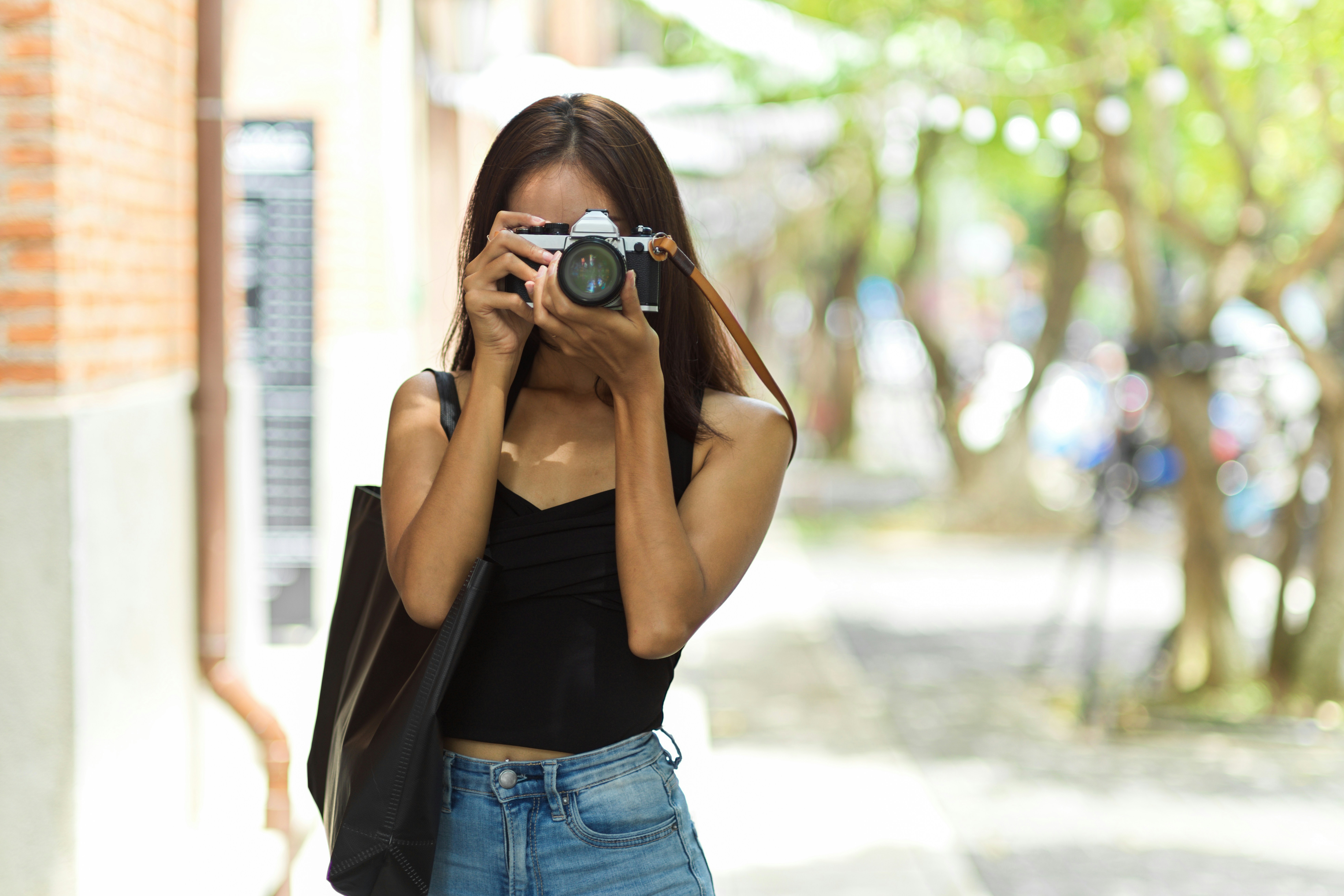 Photographer with a film camera on a city street